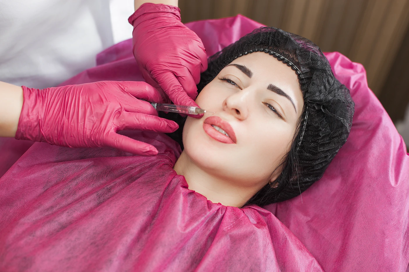 Smiling woman receiving Botox treatment at Arabella Boutique Med Spa in a relaxing, professional setting.